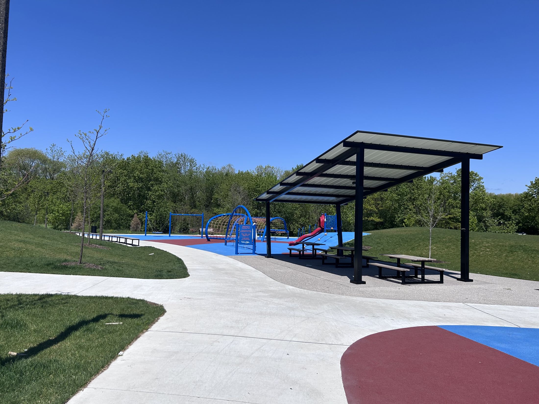 Shade structure, picnic tables and playground at Harding Park, Richmond Hill